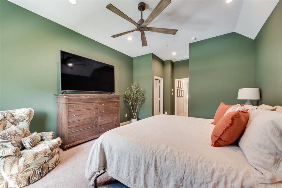 Vaulted ceiling bedroom featuring recessed lighting, an upgraded high end modern ceiling fan, and carpeted flooring Vaulted ceiling bedroom featuring recessed lighting, an upgraded high end modern ceiling fan, and carpeted flooring
