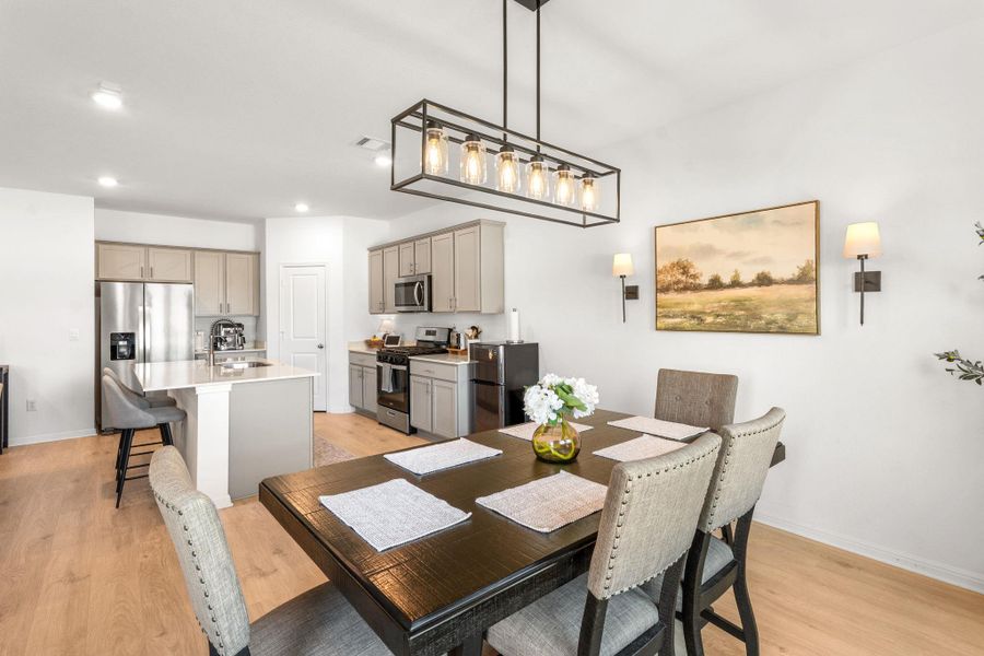 An open concept design seamlessly connects the dining area with a gourmet kitchen, perfect for entertaining. An open concept design seamlessly connects the dining area with a gourmet kitchen, perfect for entertaining.
