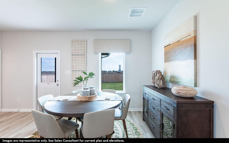 Dining room with light wood-type flooring and baseboards