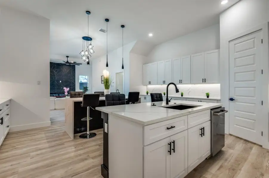 Expansive wraparound kitchen featuring dual islands with seating for nine, double ovens, a pot filler, oversized vent hood, and a walk-in pantry complete with built-in outlets. Expansive wraparound kitchen featuring dual islands with seating for nine, double ovens, a pot filler, oversized vent hood, and a walk-in pantry complete with built-in outlets.