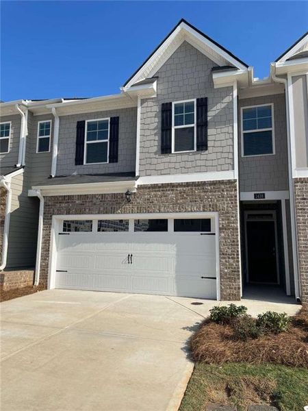 Front exterior of a new home in Inverness at Sugarloaf, Lawrenceville, GA, highlighting curb appeal (Image 1).