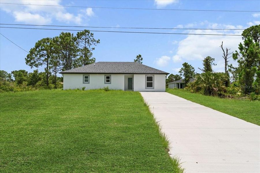 Front exterior of a new home in , Lehigh Acres, FL, highlighting curb appeal (Image 1). Front exterior of a new home in , Lehigh Acres, FL, highlighting curb appeal (Image 1).