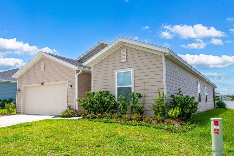 Front exterior of a new home in Trailhead Landing, Alachua, FL, highlighting curb appeal (Image 30).