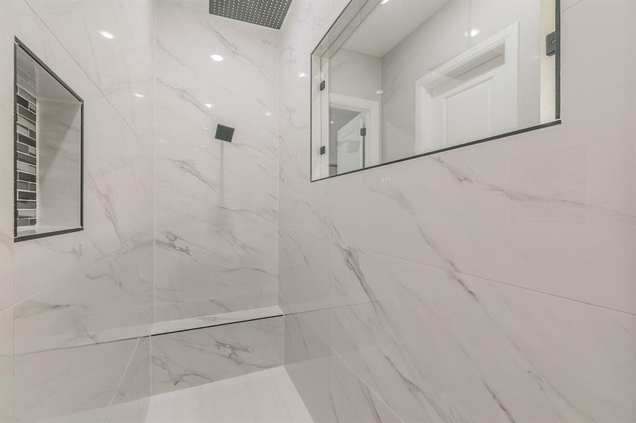 Full bath featuring a marble finish shower Full bath featuring a marble finish shower