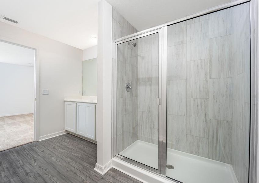 A step-in shower with tile detail in the master bathroom