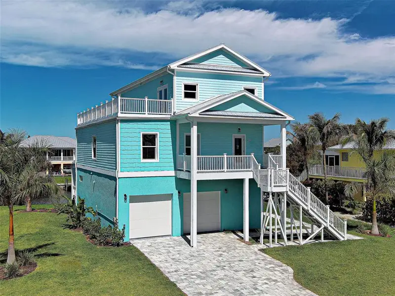 Front exterior of a new home in , Placida, FL, highlighting curb appeal (Image 1). Front exterior of a new home in , Placida, FL, highlighting curb appeal (Image 1).