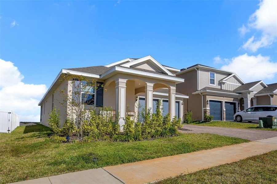 Front exterior of a new home in , Minneola, FL, highlighting curb appeal (Image 26). Front exterior of a new home in , Minneola, FL, highlighting curb appeal (Image 26).