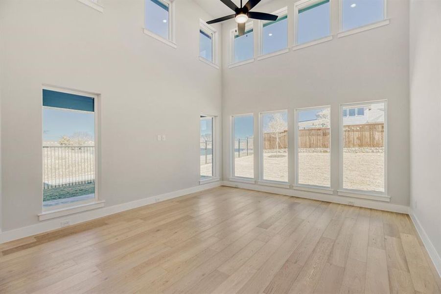 Family room with soaring ceilings and a wall of windows