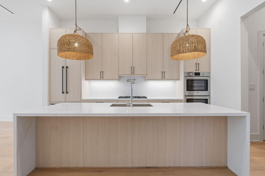 Bosch appliance suite includes double ovens, 36" gas cooktop with pot filler, and 36" integrated refrigerator.