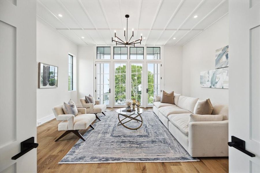 Decorative ceiling trim and a Visual Comfort chandelier draw the eye skyward in the Game Room or potential Guest Suite No 4, while northern and eastern exposures add lovely natural light.