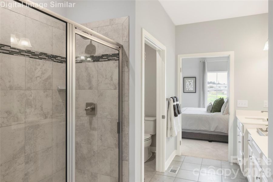Indulge in everyday luxury with a spa-like primary bath featuring a sleek walk-in shower, private water closet, and elegant tiled floors that flow seamlessly into your bedroom retreat. It’s a sanctuary of style and serenity—where comfort meets sophistication in every detail.