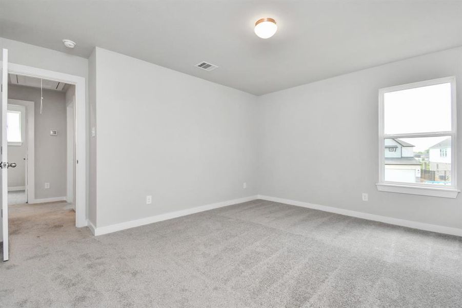 Step into this inviting bedroom retreat, boasting generously sized secondary bedrooms, plush carpeting underfoot, and ample natural light flooding through the large windows. With spacious closets to accommodate all your storage needs, this bedroom offers comfort and functionality in equal measure. Photo shown is example of completed home with similar plan. Actual colors and selections may vary.