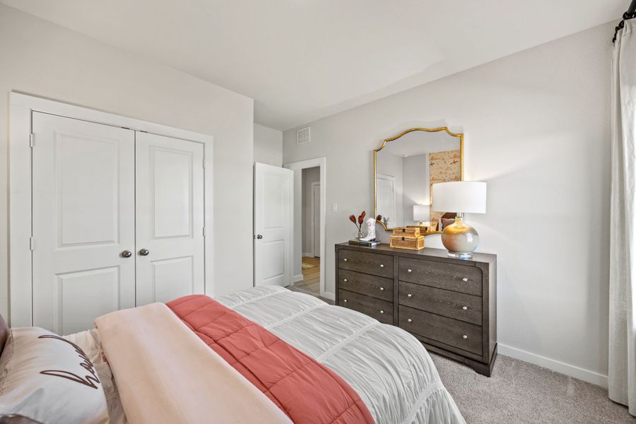 A bedroom with a bed and dresser. A bedroom with a bed and dresser.