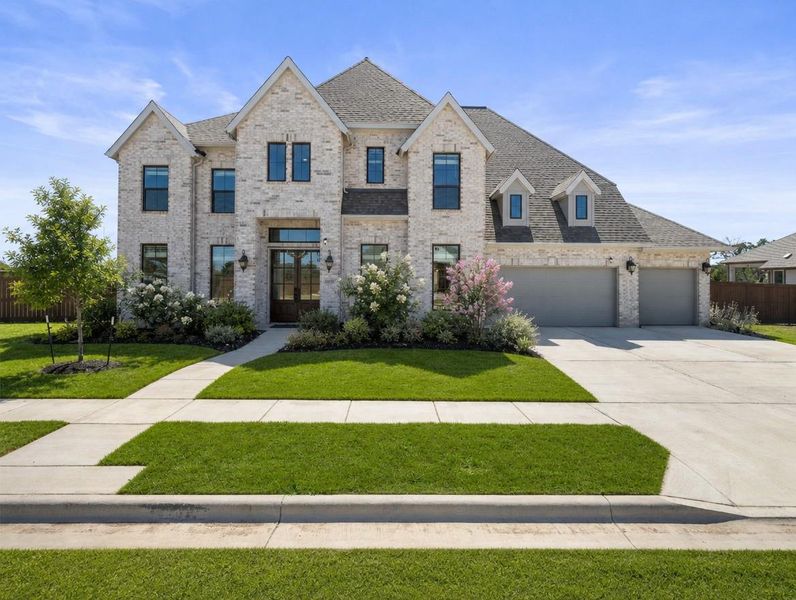 A stately residence presents a symmetrical facade of light-colored brick, complemented by a broad concrete driveway and verdant landscaping. A stately residence presents a symmetrical facade of light-colored brick, complemented by a broad concrete driveway and verdant landscaping.
