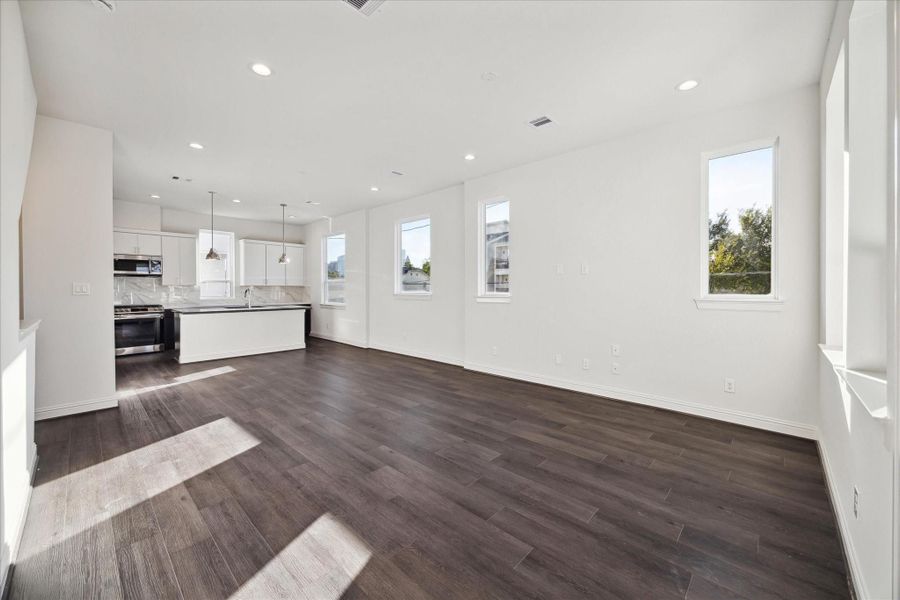 An open-concept layout effortlessly connects the living room to dining room and modern kitchen, perfect for hosting and everyday living.