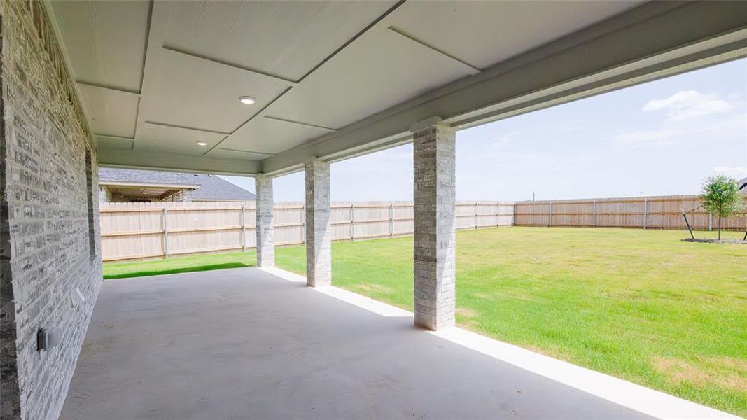 Fenced backyard with a patio area Fenced backyard with a patio area