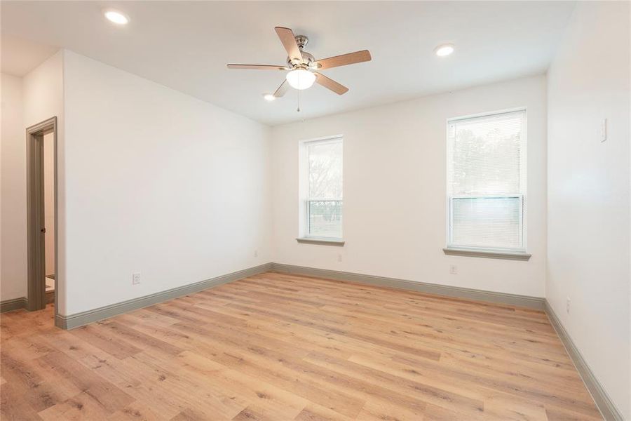 Spare room with light wood finished floors, a ceiling fan, and recessed lighting