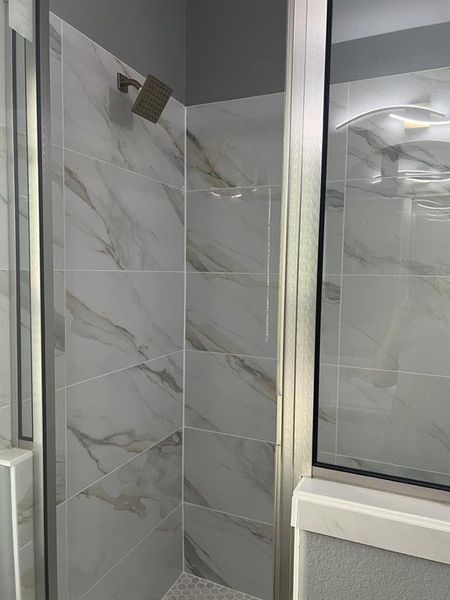 Full bathroom featuring a shower stall. Full bathroom featuring a shower stall.