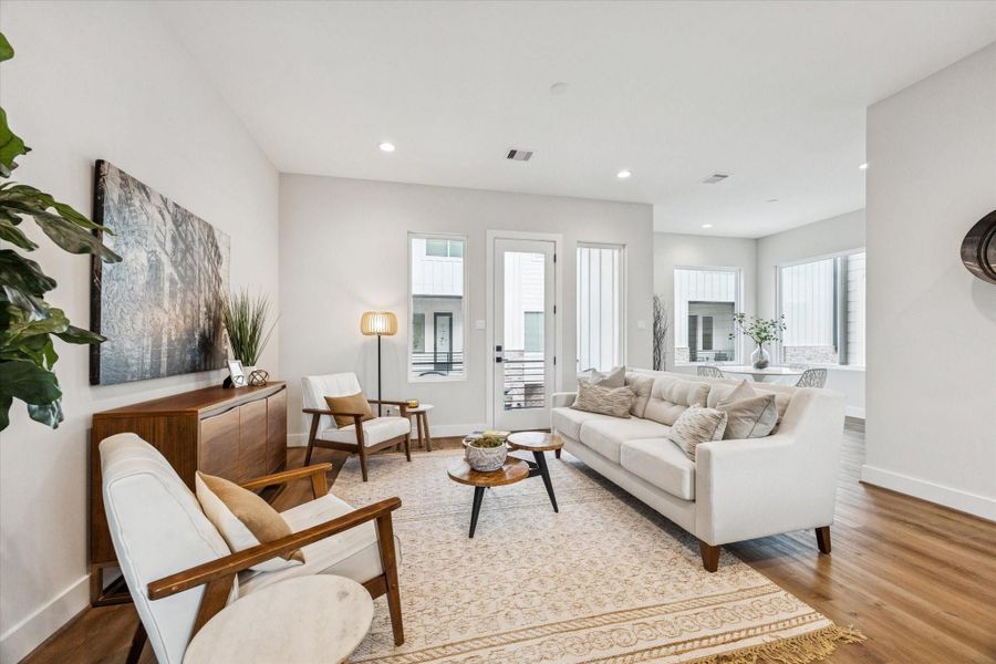 The living room has direct access to the balcony, creating a seamless indoor/ outdoor space perfect for entertaining.