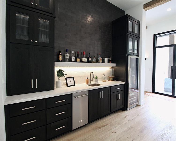 Spectacular wet bar complete with beverage cooler and ice maker.