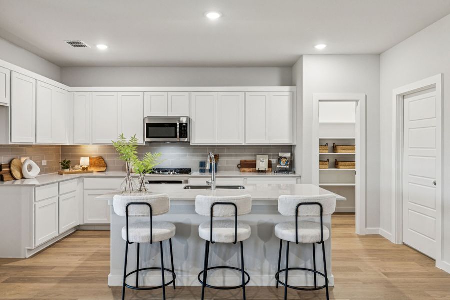 Kitchen in the Oscar home plan by Trophy Signature Homes – REPRESENTATIVE PHOTO