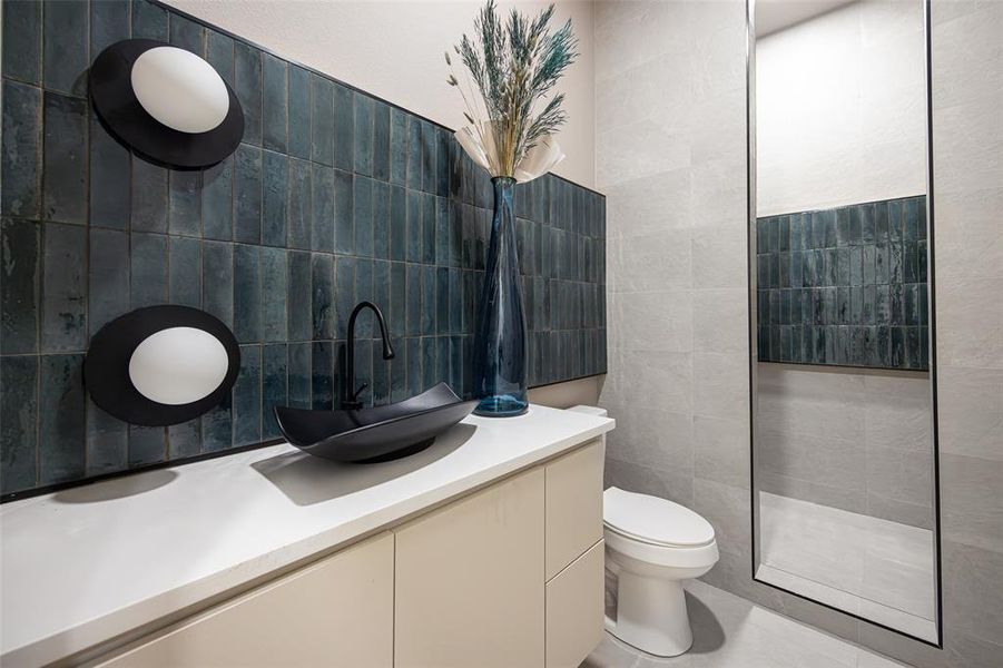 Bathroom with vanity and tile walls