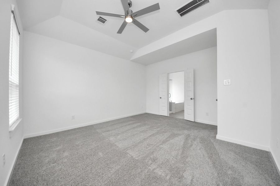 Come and unwind after a long day in this magnificent primary suite! This spacious room features plush carpet, warm paint, high ceilings and large windows with privacy blinds. Sample photo of completed home with similar floor plan. Actual colors and selections may vary. Come and unwind after a long day in this magnificent primary suite! This spacious room features plush carpet, warm paint, high ceilings and large windows with privacy blinds. Sample photo of completed home with similar floor plan. Actual colors and selections may vary.