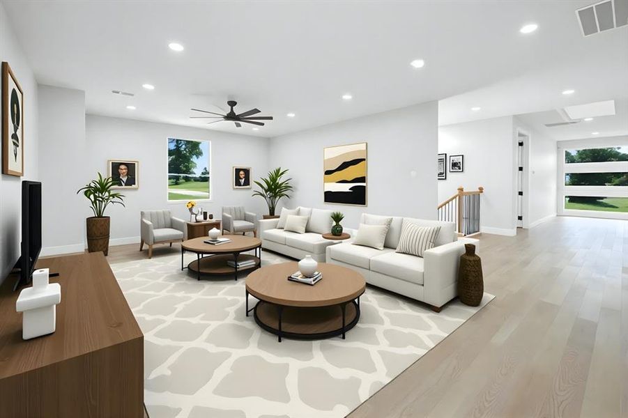 Living room featuring light wood finished floors, ceiling fan, and recessed lighting