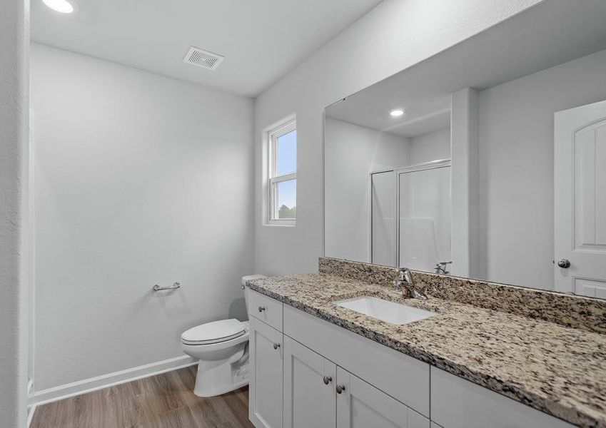 Master bath with a granite vanity.