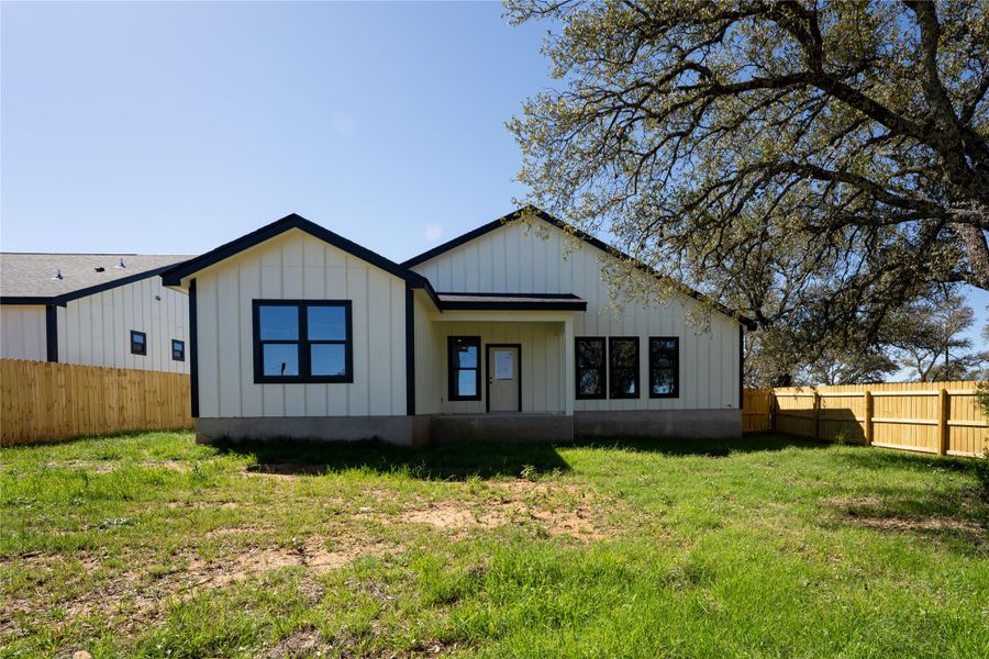 Rear view of house featuring board and batten siding