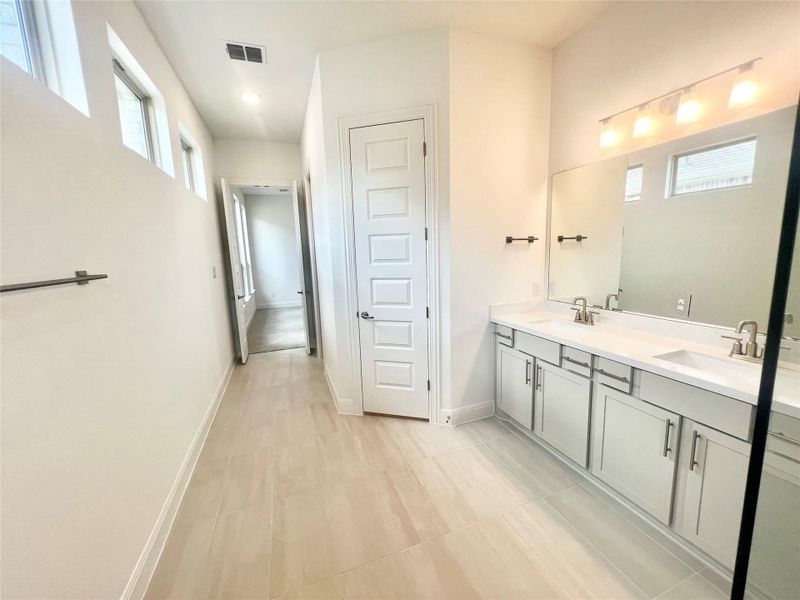 Bathroom with double vanity and baseboards Bathroom with double vanity and baseboards