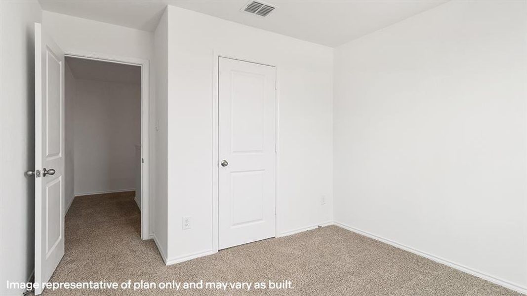 Unfurnished bedroom featuring light colored carpet