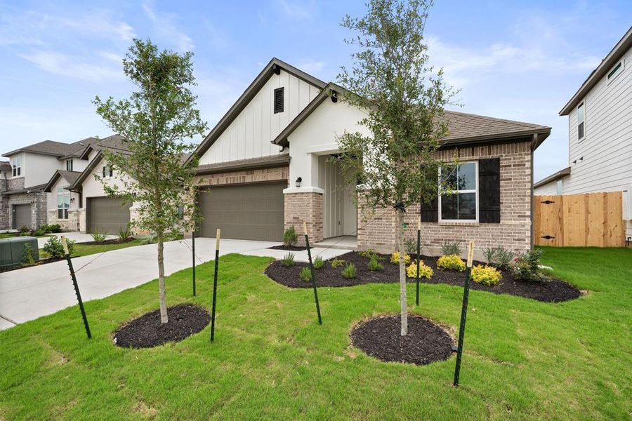 Front exterior of a new home in Lagos Reserve, Manor, TX, highlighting curb appeal (Image 22). Front exterior of a new home in Lagos Reserve, Manor, TX, highlighting curb appeal (Image 22).