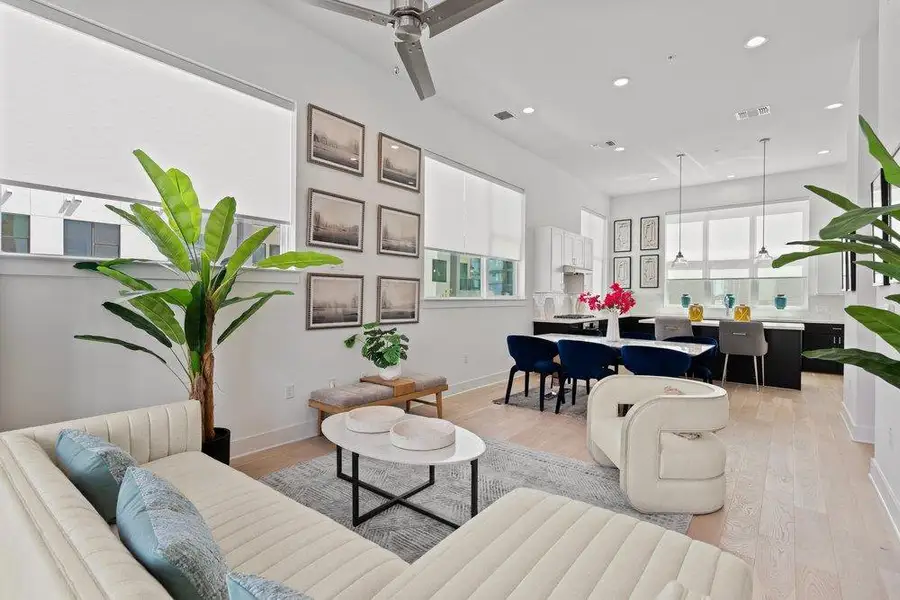 An open-concept living space integrates a casual dining area and a modern kitchen. An open-concept living space integrates a casual dining area and a modern kitchen.