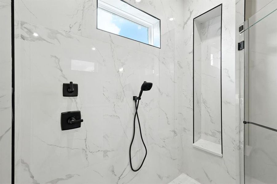 Bathroom featuring a marble finish shower