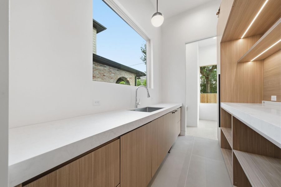 Butler's Pantry with extra sink, amazing cabinetry and second dishwasher for seamless entertaining and storage.