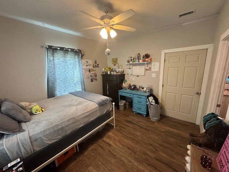 Bedroom with dark wood-style flooring and ceiling fan Bedroom with dark wood-style flooring and ceiling fan