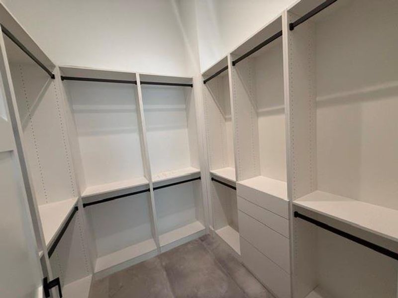 Elegant and spacious walk-in closet with ample shelving and hanging space for a perfectly organized wardrobe.