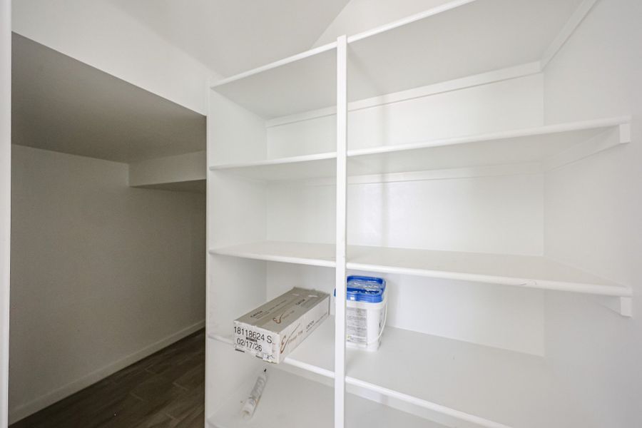 A white shelving unit. A white shelving unit.