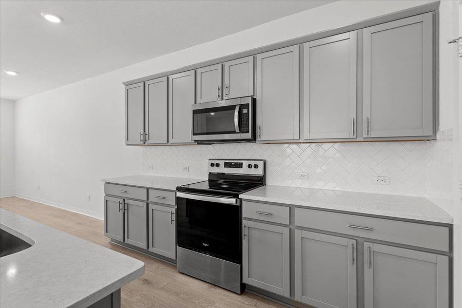 Culinary aspirations ignite in this well-appointed kitchen, featuring modern appliances and ample counter space.