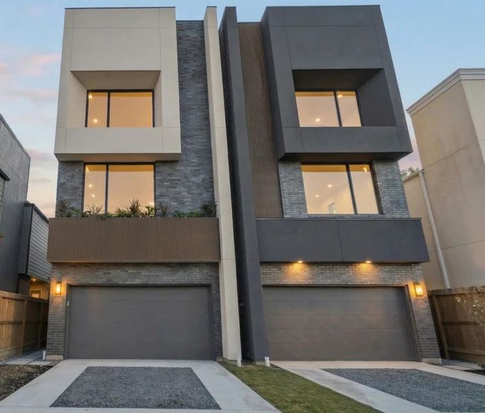 Gorgeous exterior with custom obsidian brick and handcrafted stucco finish with rich colors and artisanal texture.