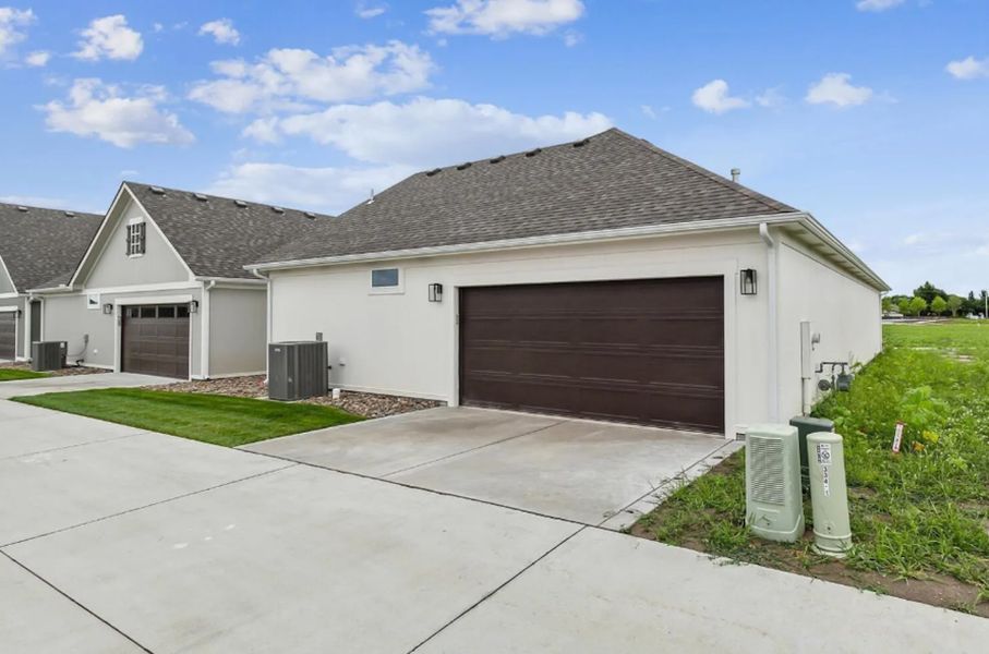 Front exterior of a new home in The Courtyards at Cornerstone, Andover, KS, highlighting curb appeal (Image 2). Front exterior of a new home in The Courtyards at Cornerstone, Andover, KS, highlighting curb appeal (Image 2).