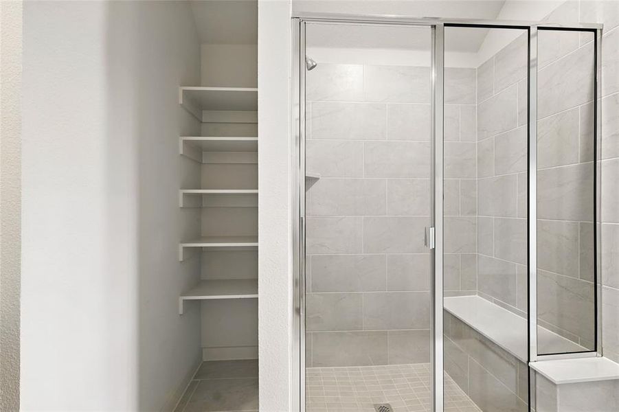 Bathroom featuring a shower stall and light tile patterned flooring Bathroom featuring a shower stall and light tile patterned flooring