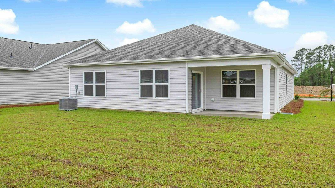 Exterior details and patio area of a home in Cedar Hill Landing, Navassa (Image 3).
