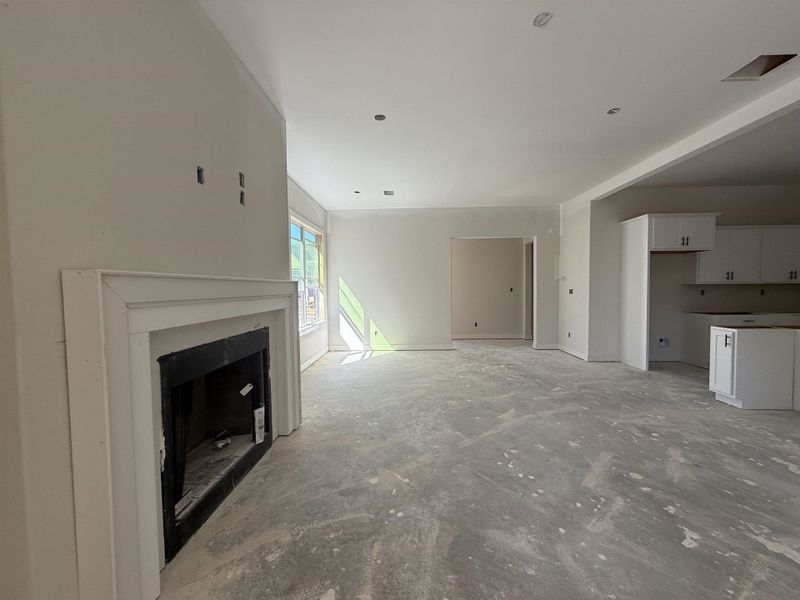 Unfurnished living room featuring a fireplace and concrete flooring