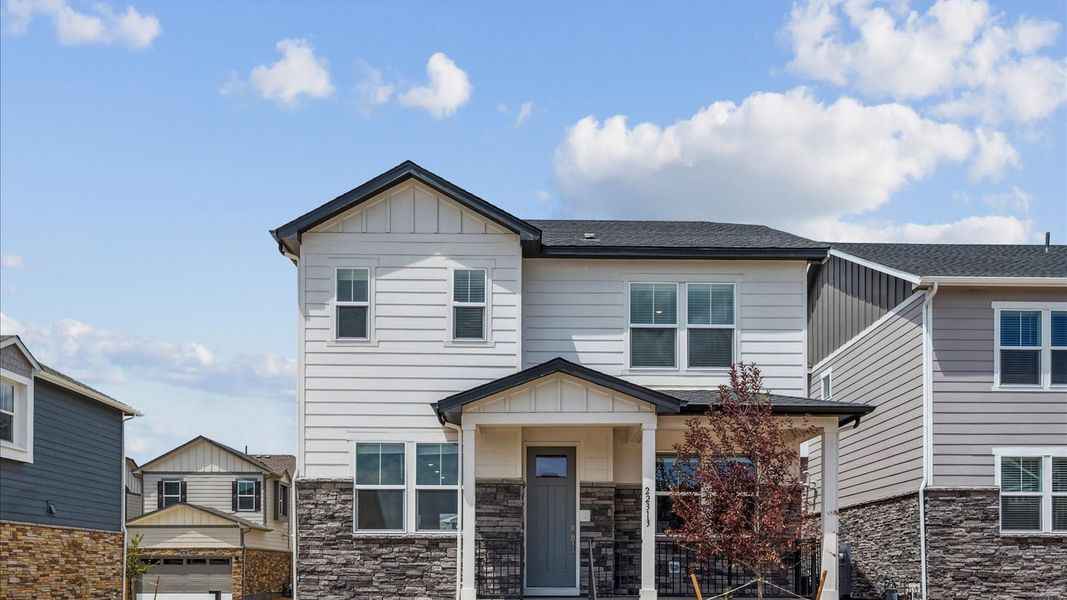 Front exterior of a new home in Horizon Uptown, Aurora, CO, highlighting curb appeal (Image 1).