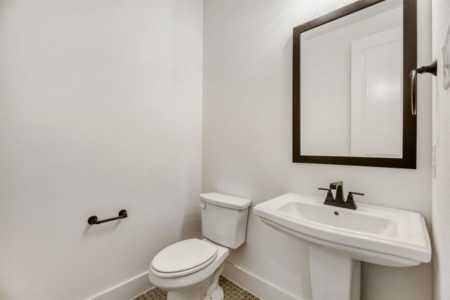 Bathroom with toilet and baseboards