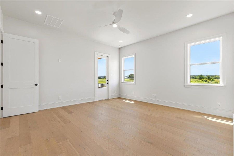 The primary bedroom is spacious with abundant natural light and opens directly to the back patio. The primary bedroom is spacious with abundant natural light and opens directly to the back patio.