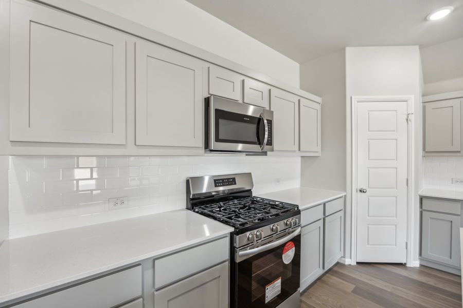 Kitchen in the Hadley home plan by Trophy Signature Homes – REPRESENTATIVE PHOTO