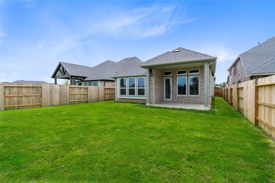 The backyard green space is fully fenced for added privacy.